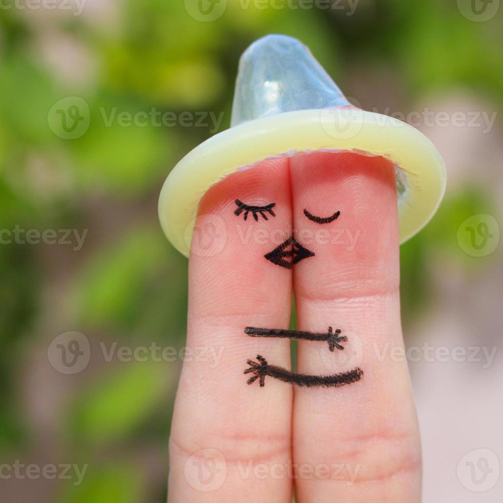 Finger art of a Happy couple. The happy couple kissing and hugging. The concept of safe sex. photo