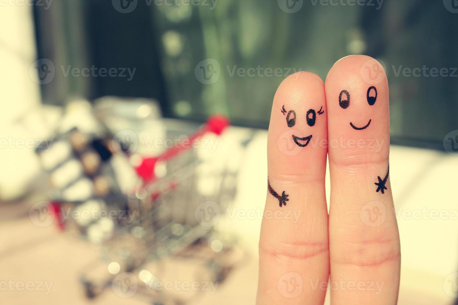 Finger art of a Happy couple. A man and a woman hug on the background shopping cart. Toned image. photo