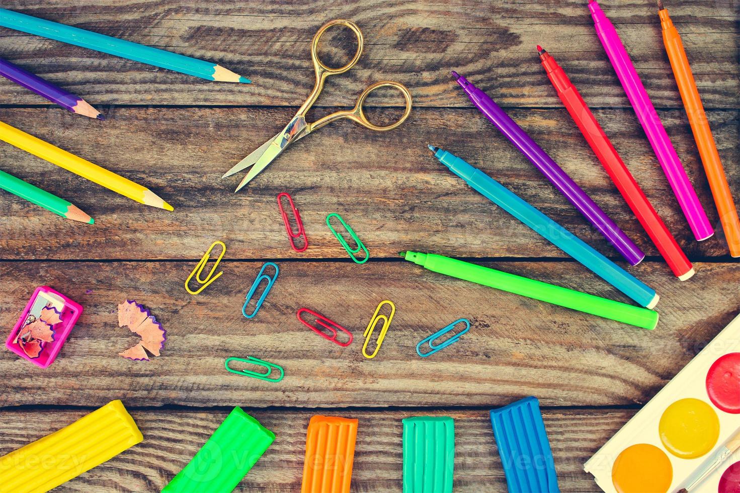 Stationery objects. School supplies on old wood background. Toned image. photo