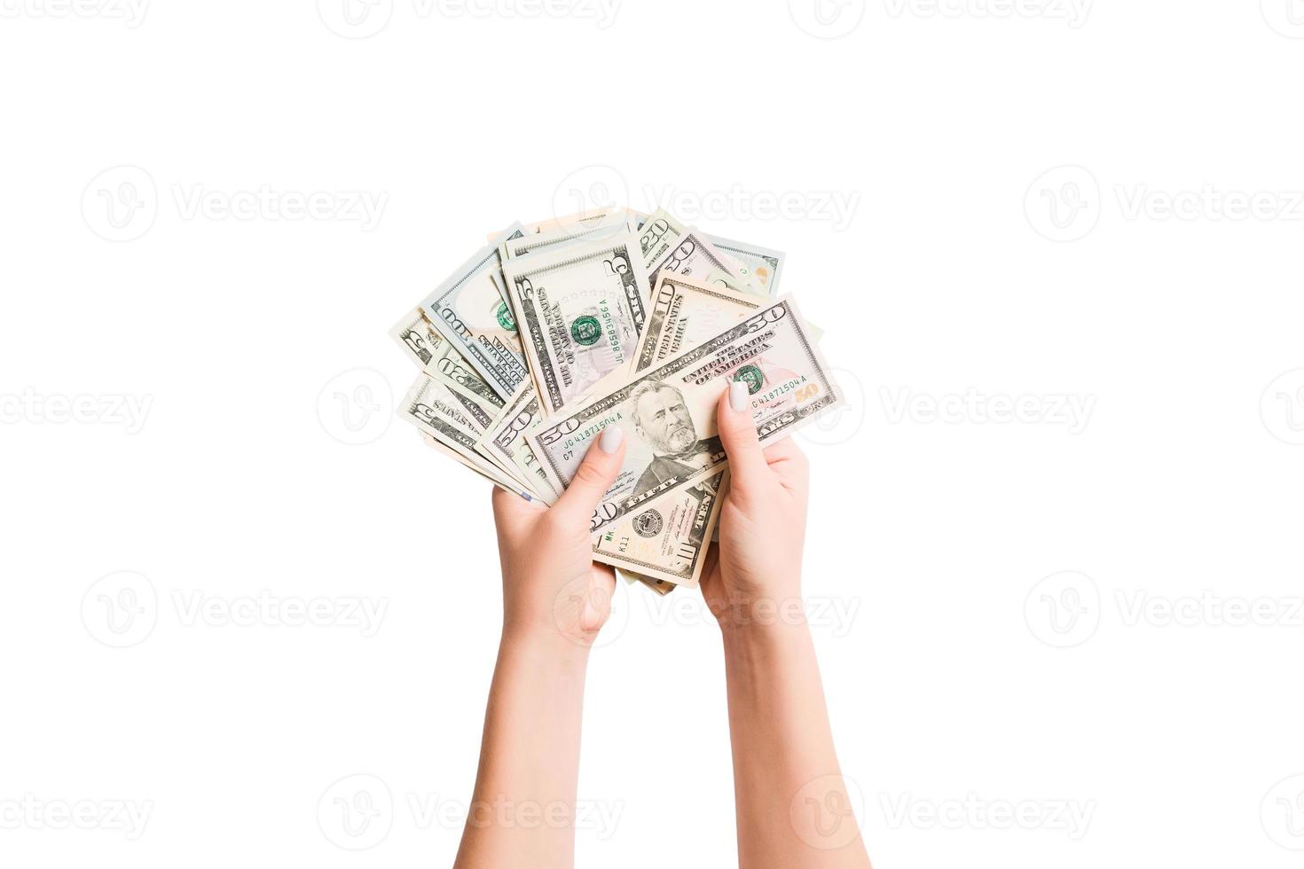 Isolated image of female hands counting dollars on white background. Top view of salary and wages concept photo