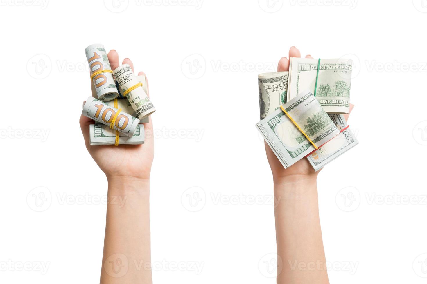 Top view of dollar bills in tubes in female hands on white isolated background. Business concept photo