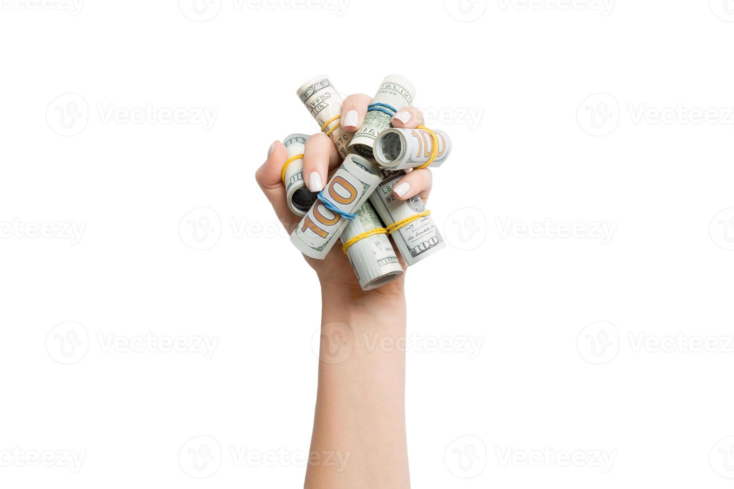 Top view of rolled up in tubes dollar bills in female palm on white isolated background. Poverty and debt concept with empty space for your design photo