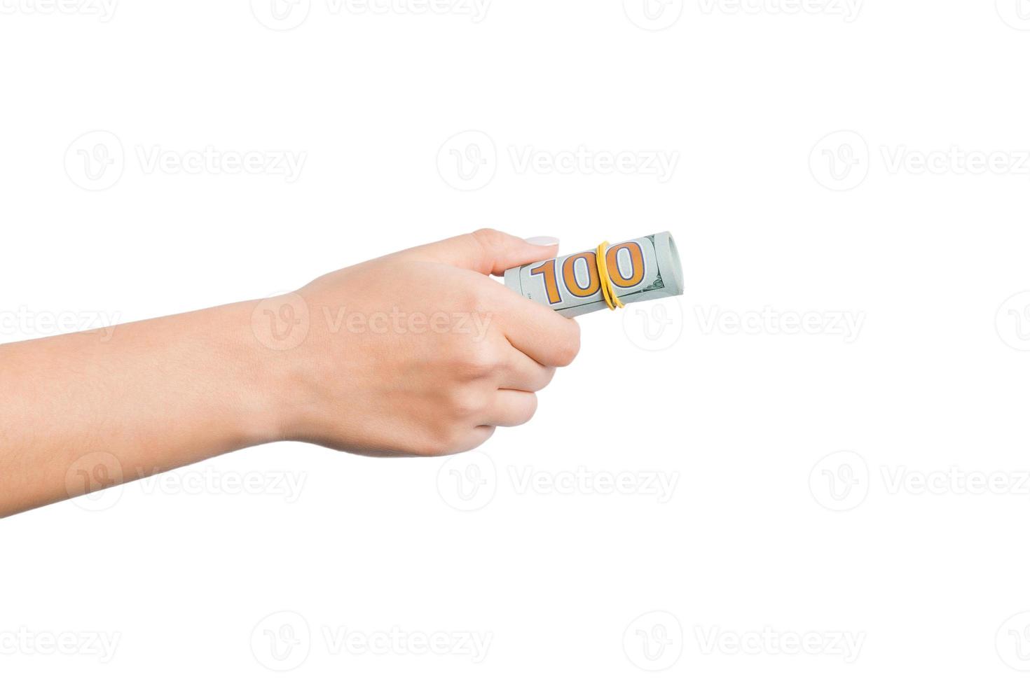 Isolated image of female hand holding a bundle of dollars on white background. Payment concept photo