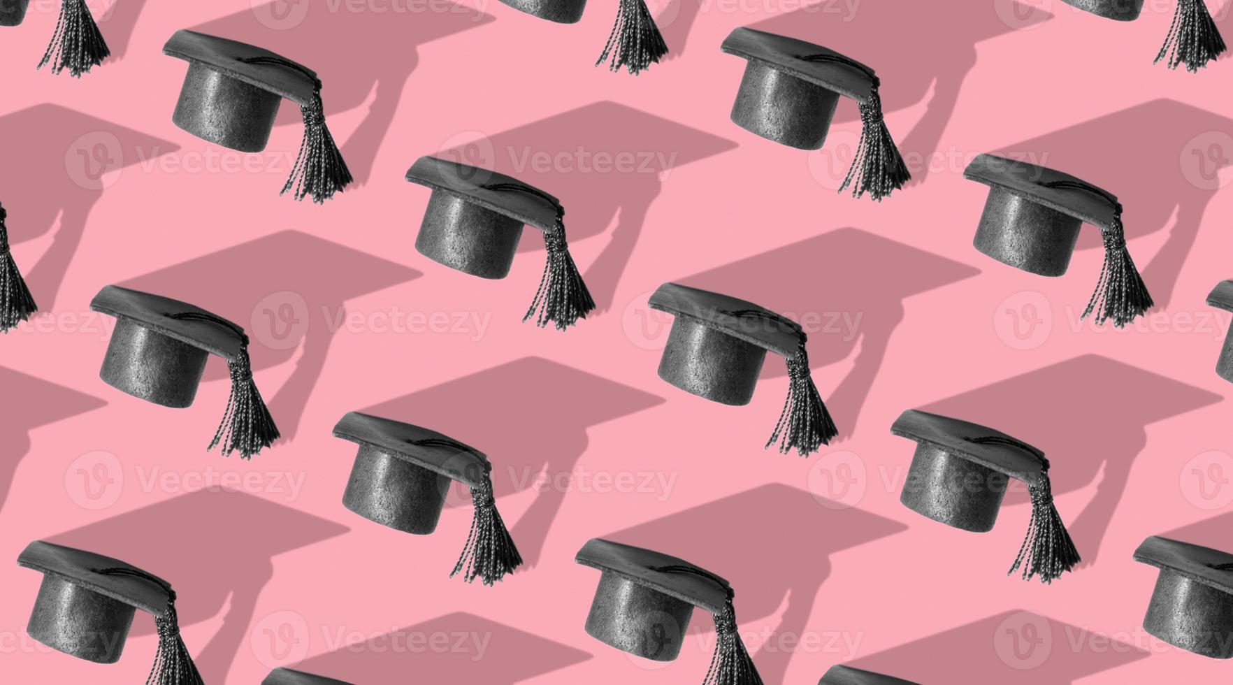 Pattern with black graduated cap pink background with hard shadow. Education background photo
