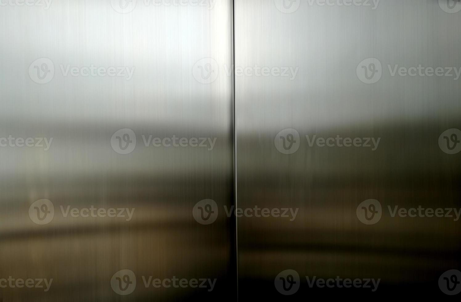 https://static.vecteezy.com/system/resources/previews/021/755/735/non_2x/stainless-steel-large-sheet-with-light-hitting-the-surface-inside-passenger-elevator-reflection-of-light-on-a-shiny-metal-texture-stainless-steel-background-metal-texture-background-photo.jpg