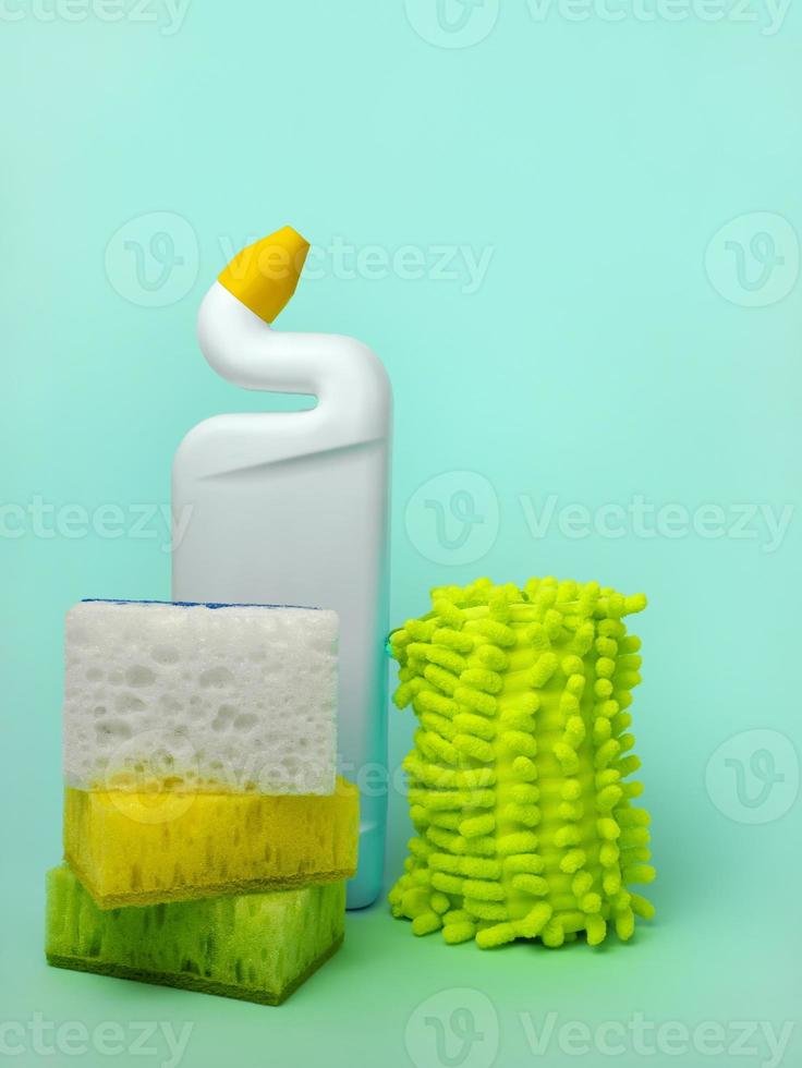 Cleaning agent, sponges and cleaning cloths on a blue background. The concept of cleanliness photo