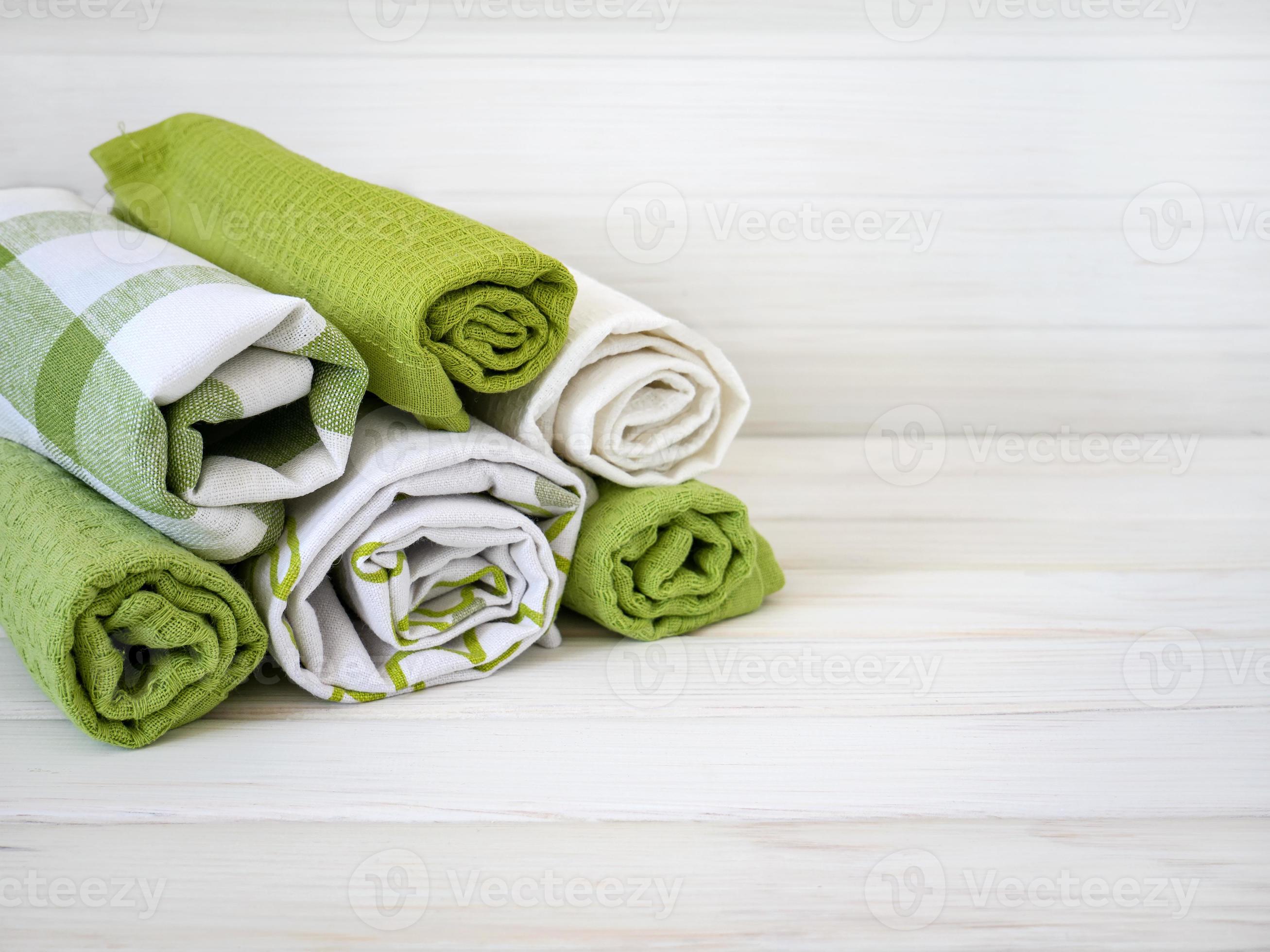 A pile of neatly folded towels on wooden background. Production of
