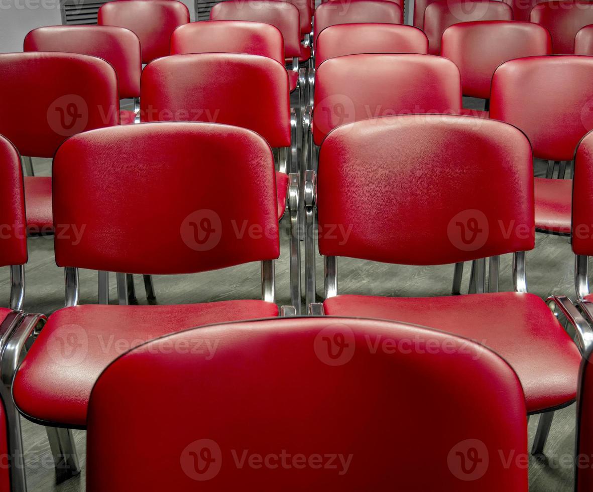Seats in the audience for conference or presentation participants. Holding mass events. Classic empty chairs in a row photo