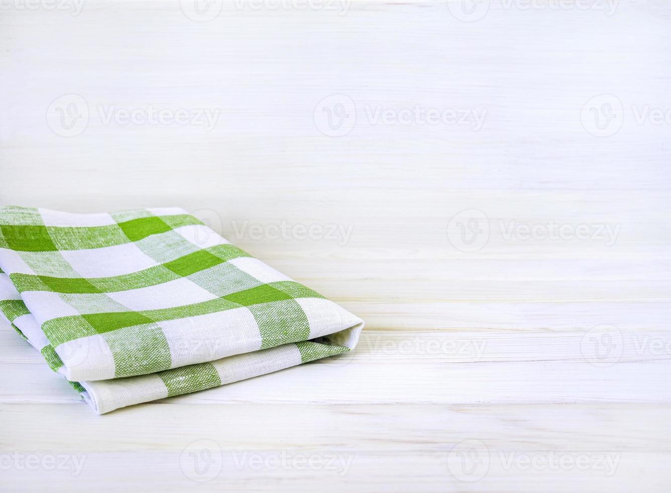 A pile of neatly folded towels on wooden background. Production of