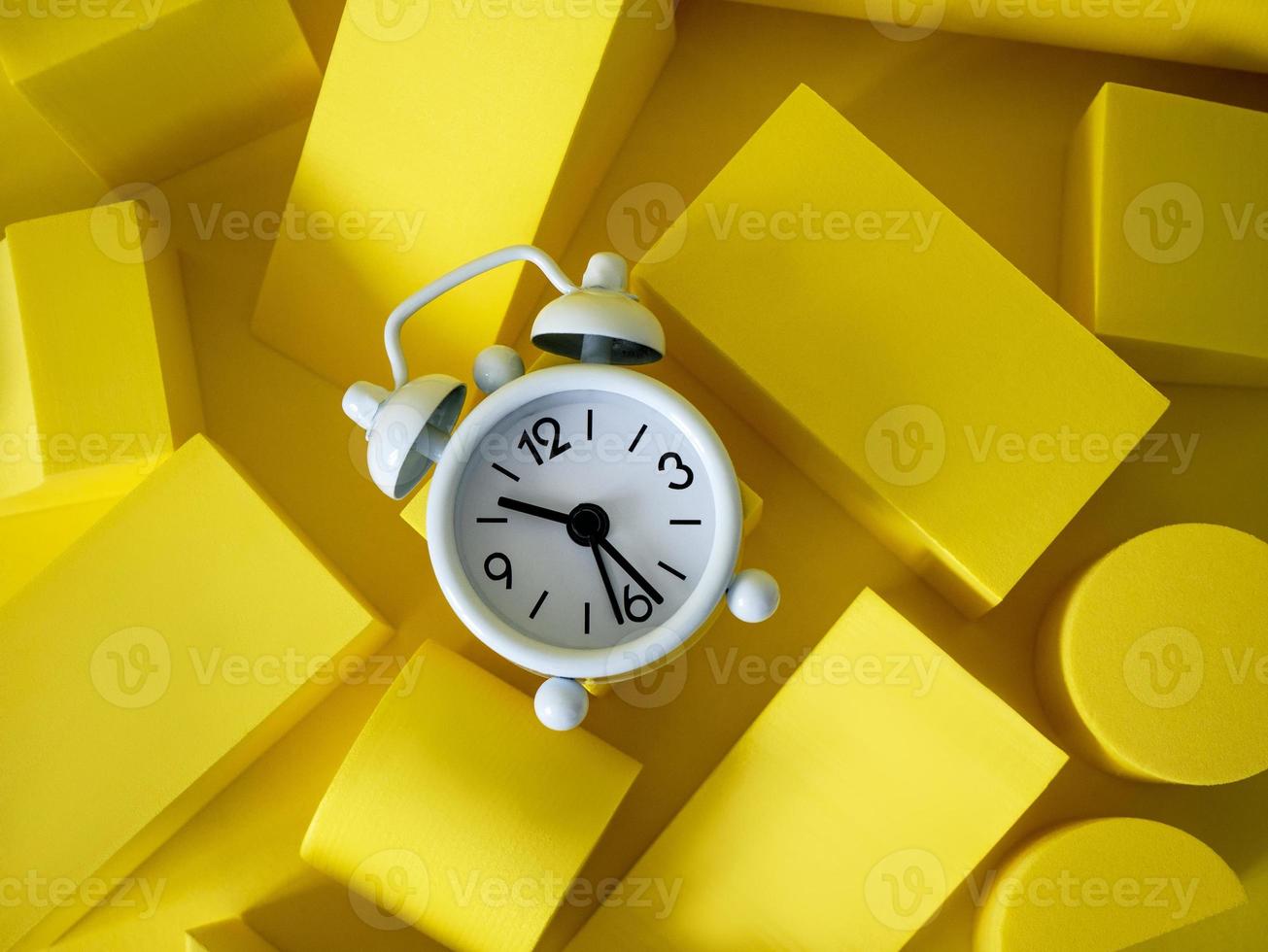 composition with podiums for the presentation of products. A scene layout with geometric shapes and a clock. copy space photo