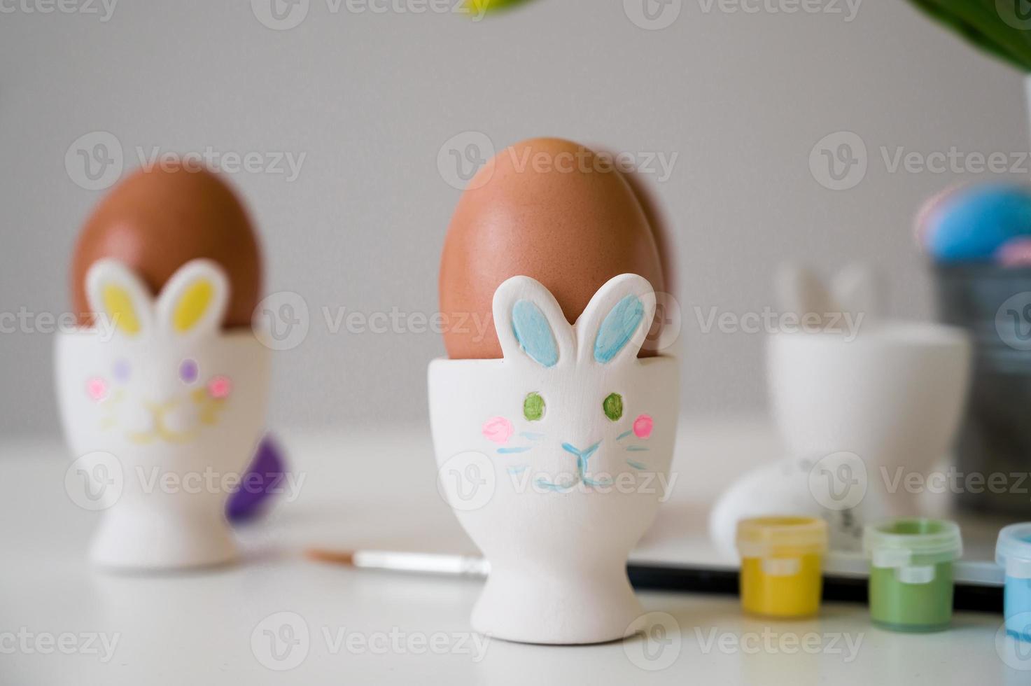 Easter greeting card with pastel paint,eggs in bunny holders etc photo