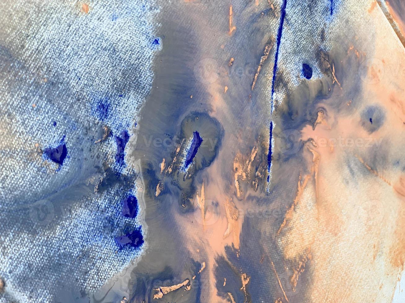 A blue and orange painting with a white background and blue paint. photo