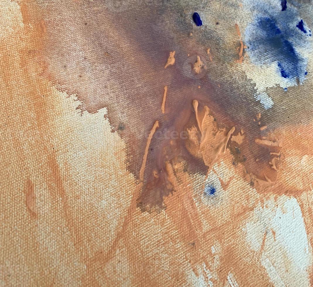 A blue and orange painting with a white background and blue paint. photo