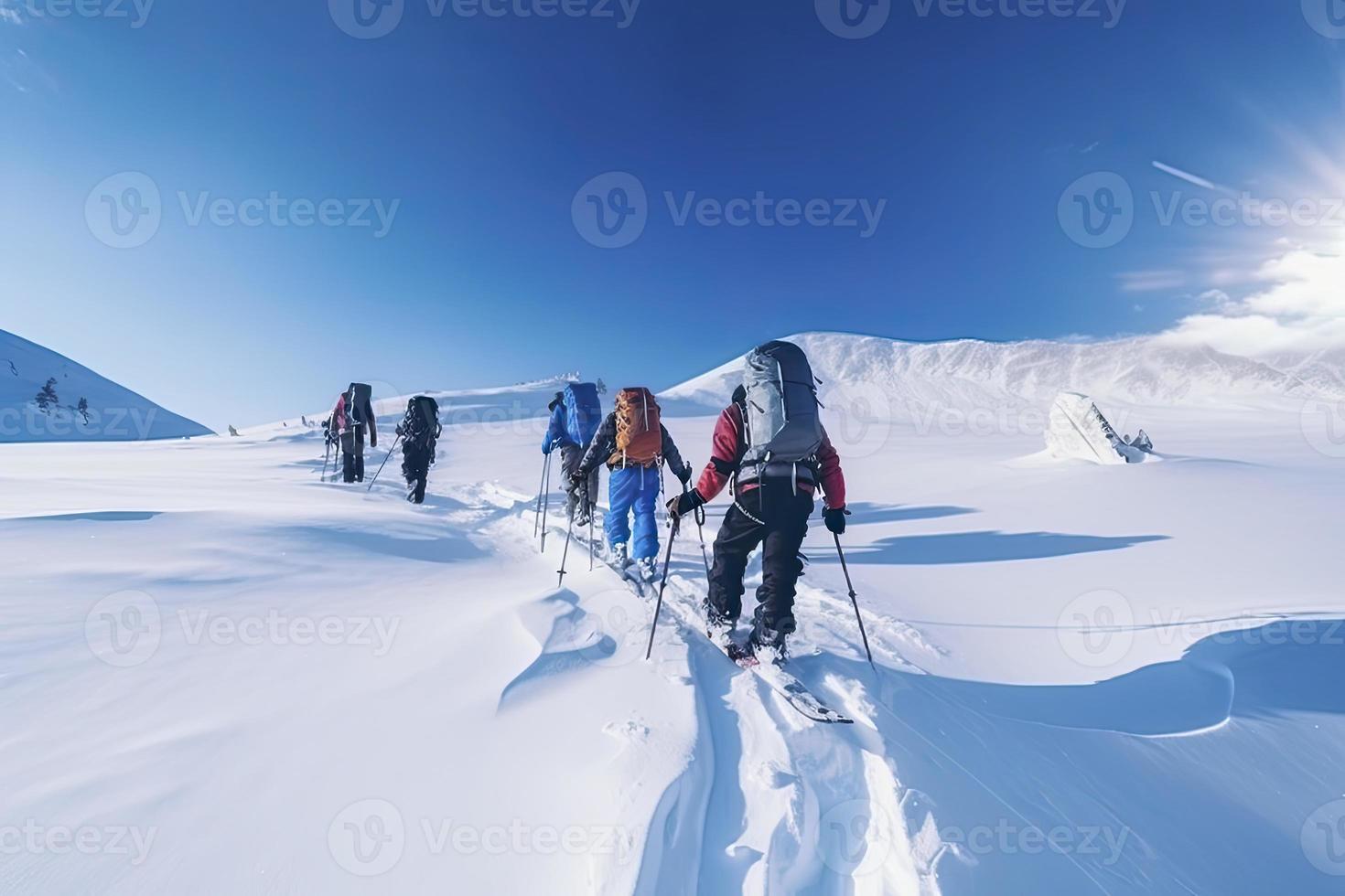 Group of mountain climbers climb the slope to the peak in sunny weather with sledges and tents equipment for overnight stays photo