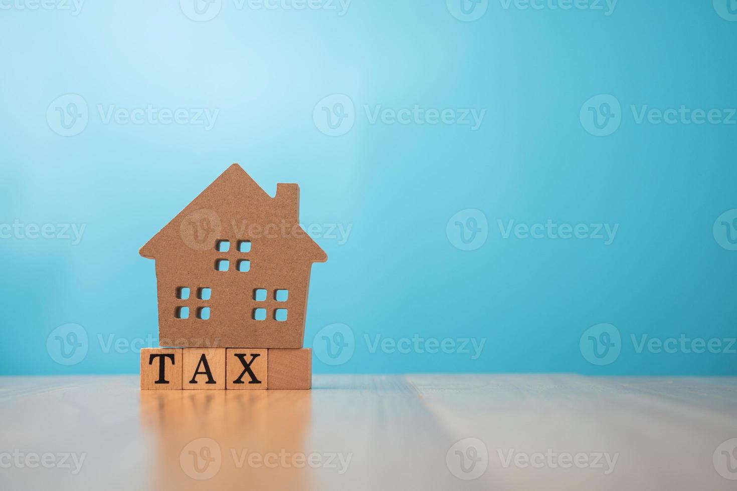 Wooden house on tax. The concept of finance and investment in property residential and tax payment. photo