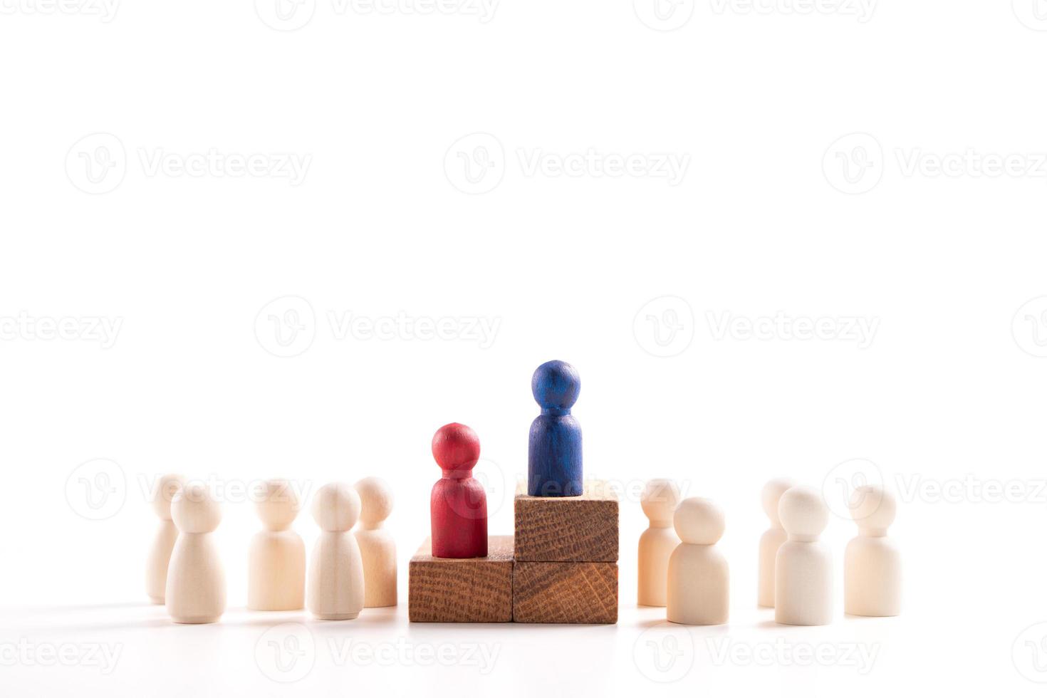 Wooden figure standing on the box for show influence and empowerment. Concept of business leadership for leader team, successful competition winner and Leader with influence photo
