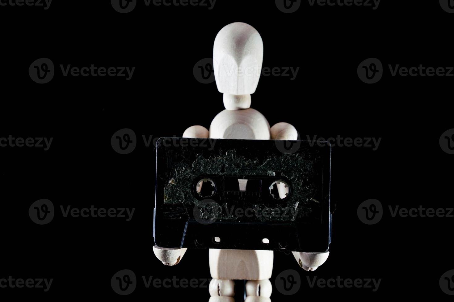 Wooden mannequin figurine on dark background photo
