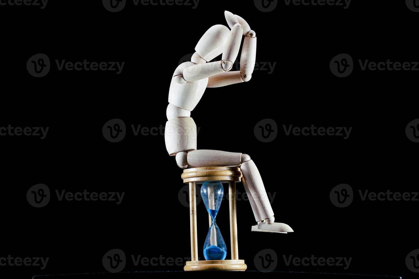 Wooden mannequin figurine on dark background photo