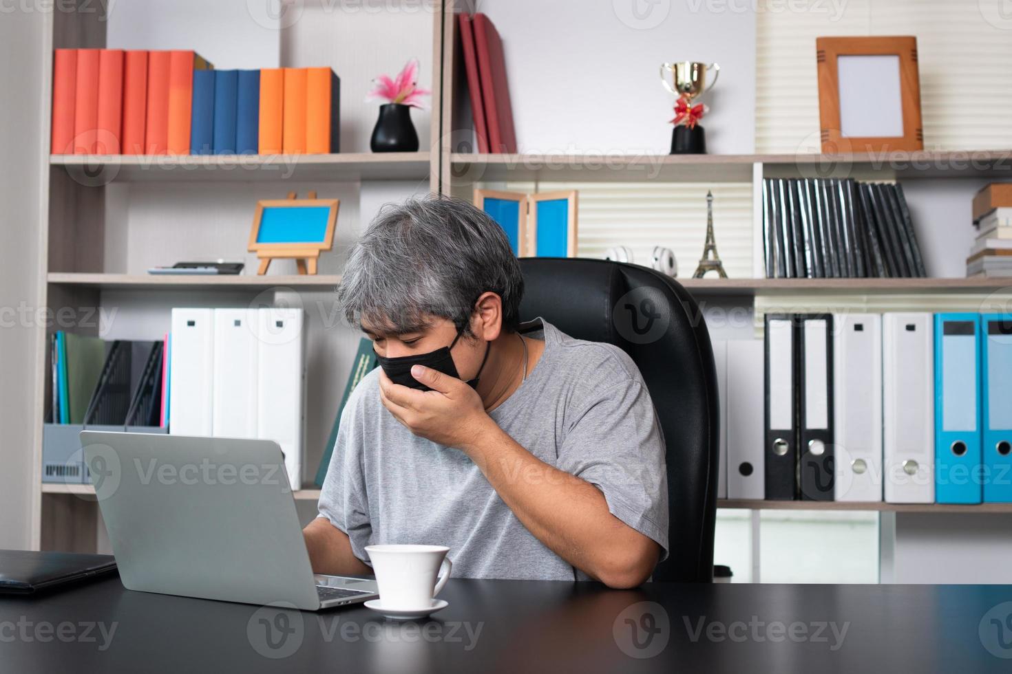 Asian man wearing masks and working from home during Covid-19 quarantine, Concept of social distance and prevention be prevalent from coronavirus or Covid 19 photo