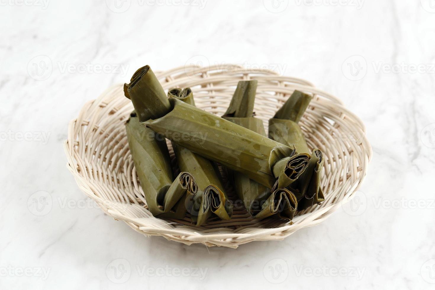 Lontong, Indonesian Rice Cake Wrapped with Banana Leaf photo
