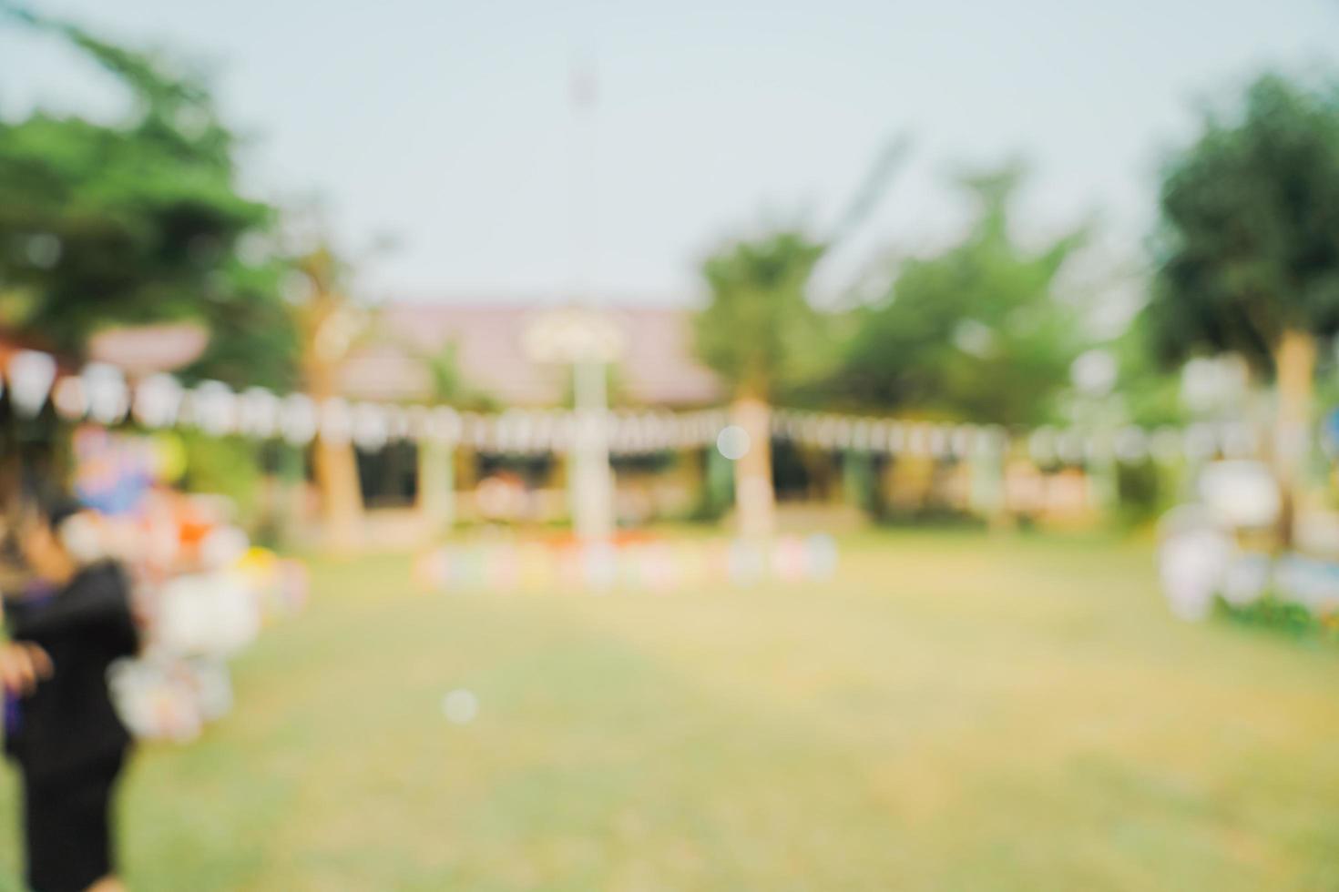 Defocused bokeh and blur background of garden trees in sunlight with vintage toned. photo