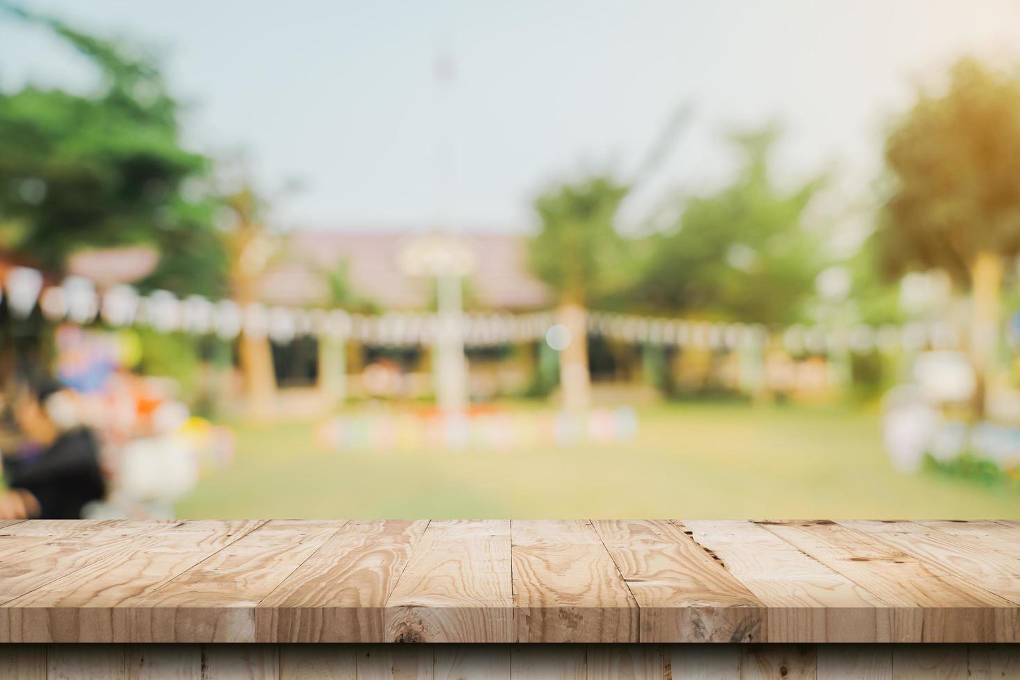 Empty wooden table top and Abstract blurred light bokeh and blur background of garden trees in sunlight. product display template with copy space. photo