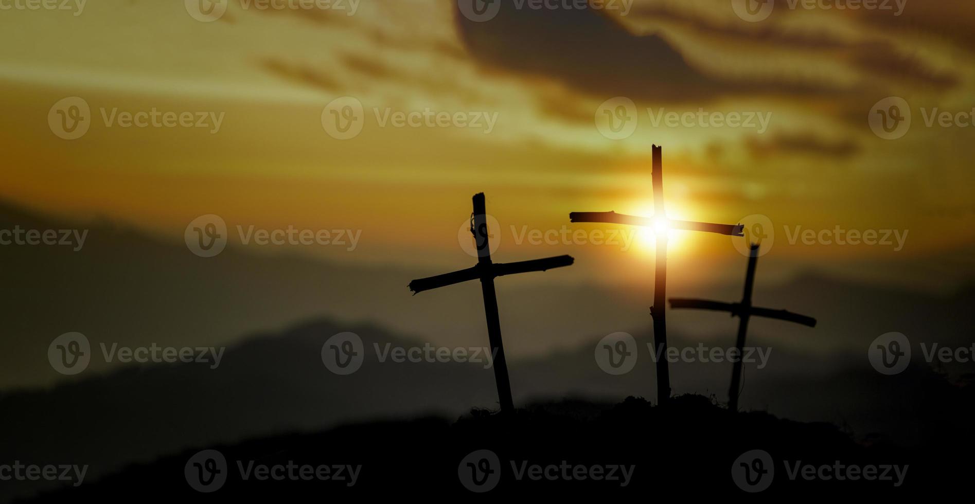 Crucifixion Of Jesus Christ - Cross At Sunset. The concept of the resurrection of Jesus in Christianity. Crucifixion on Calvary or Golgotha hills in holy bible. photo