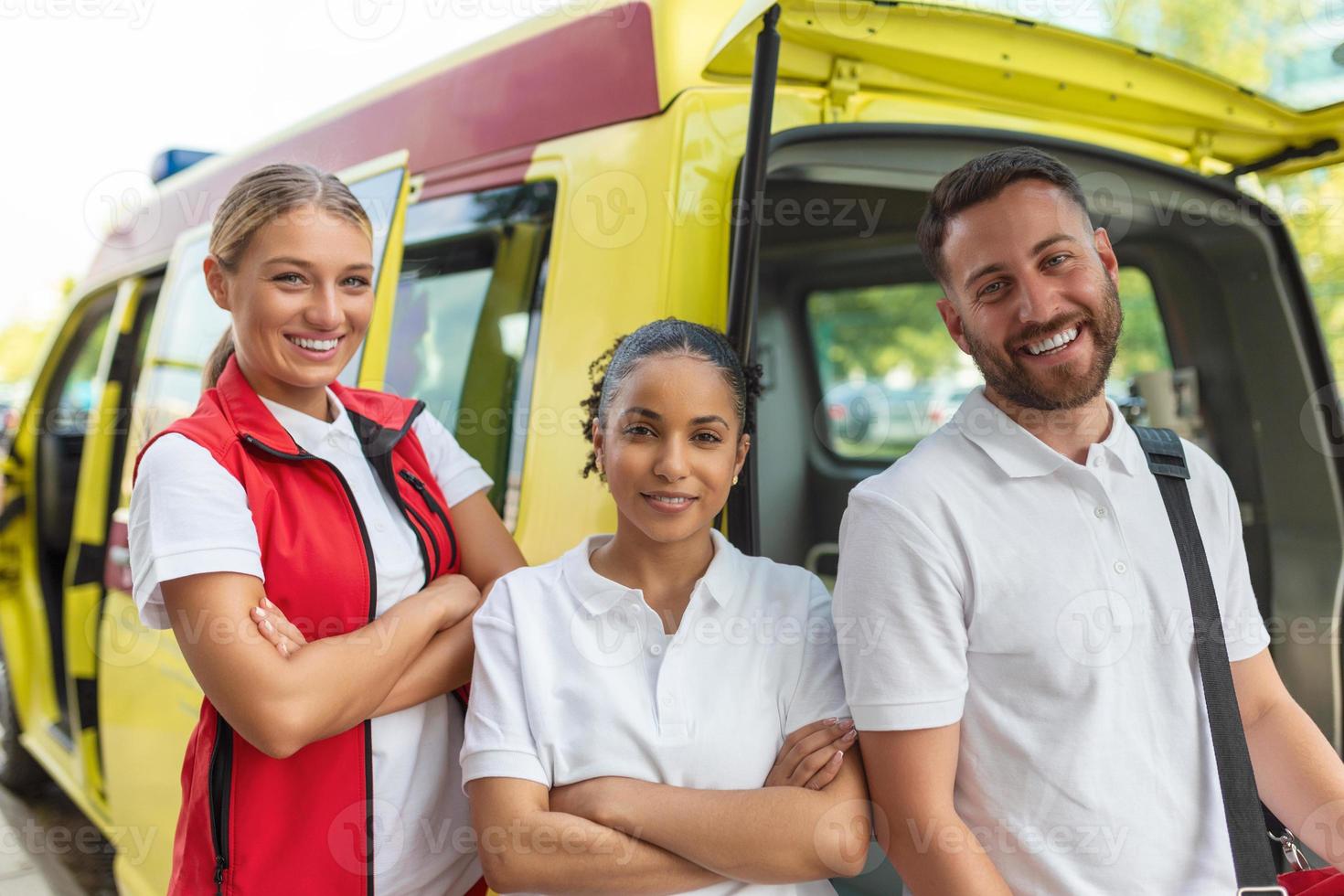 Paramedics at work with an ambulance. Paramedic nurse and emergency doctor at ambulance with kit photo