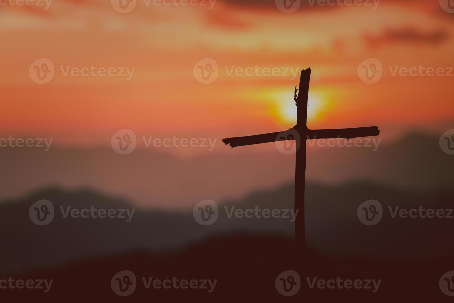Crucifixion Of Jesus Christ - Cross At Sunset. The concept of the resurrection of Jesus in Christianity. Crucifixion on Calvary or Golgotha hills in holy bible. photo