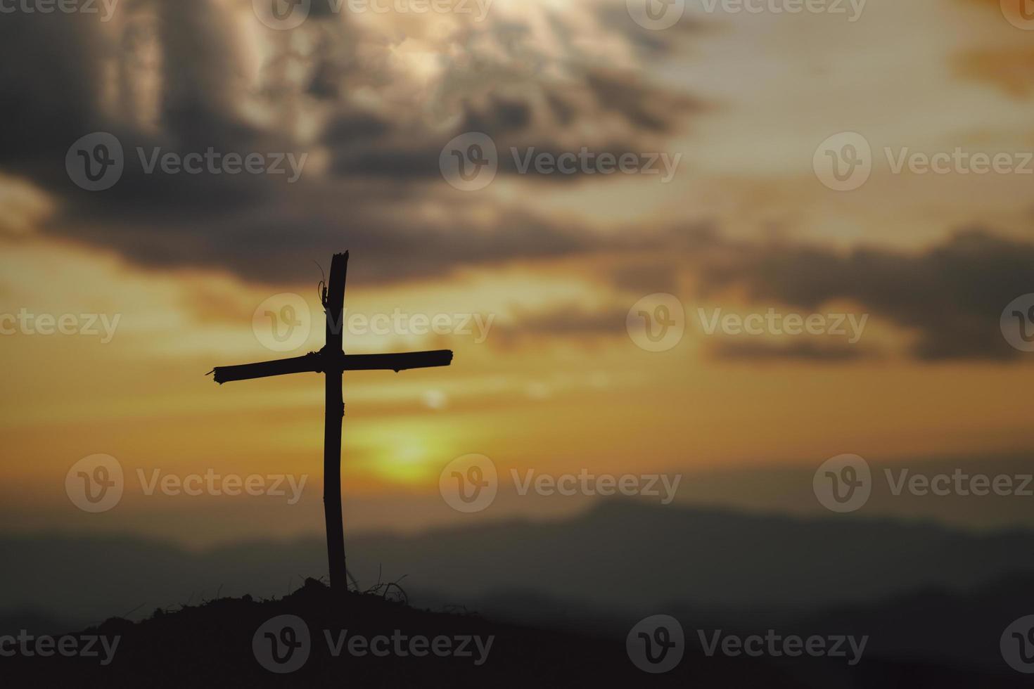 Crucifixion Of Jesus Christ - Cross At Sunset. The concept of the resurrection of Jesus in Christianity. Crucifixion on Calvary or Golgotha hills in holy bible. photo