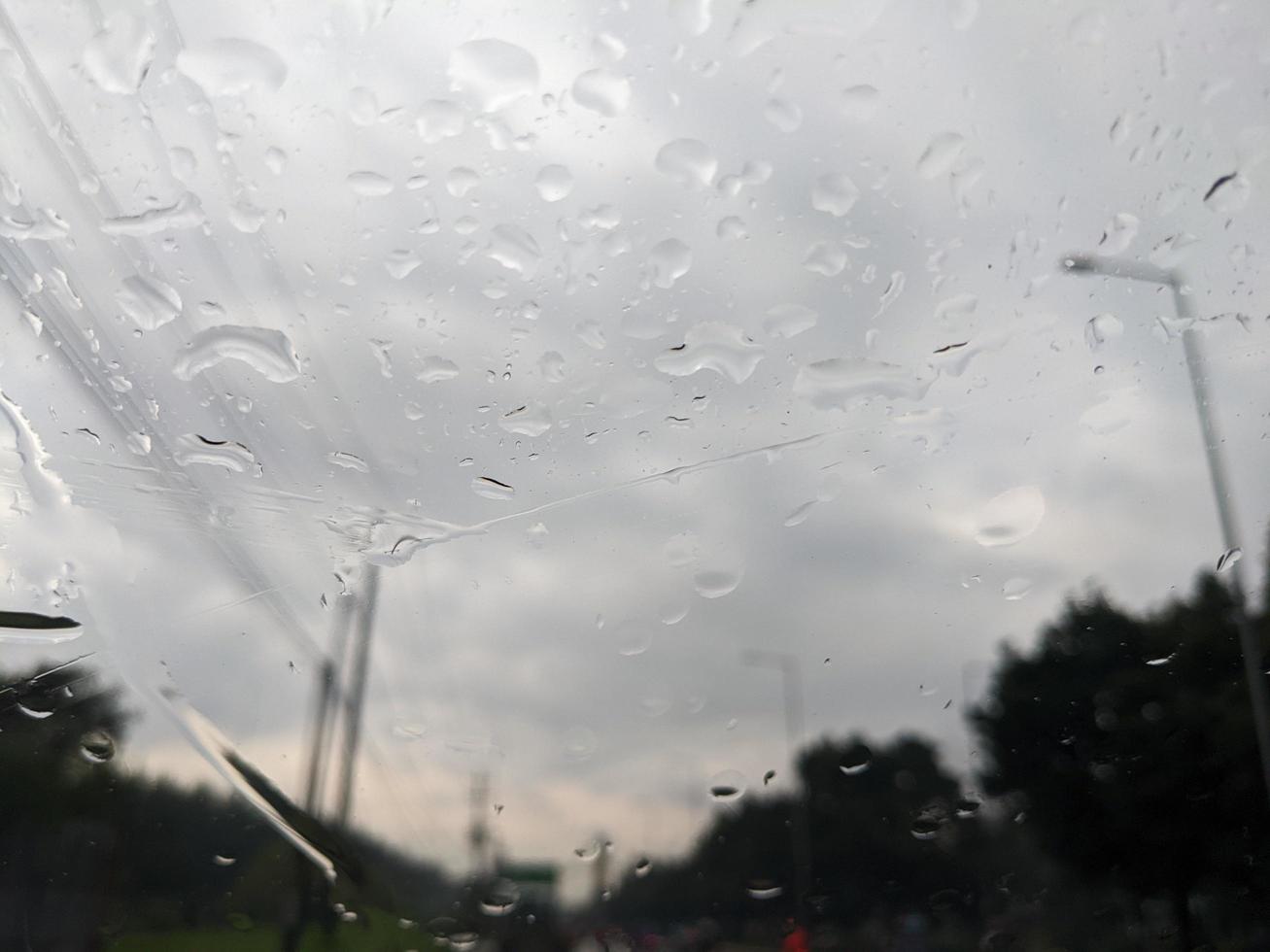 Drop water on the front glass cover of the car. The photo is suitable to use for nature background and nature content media.