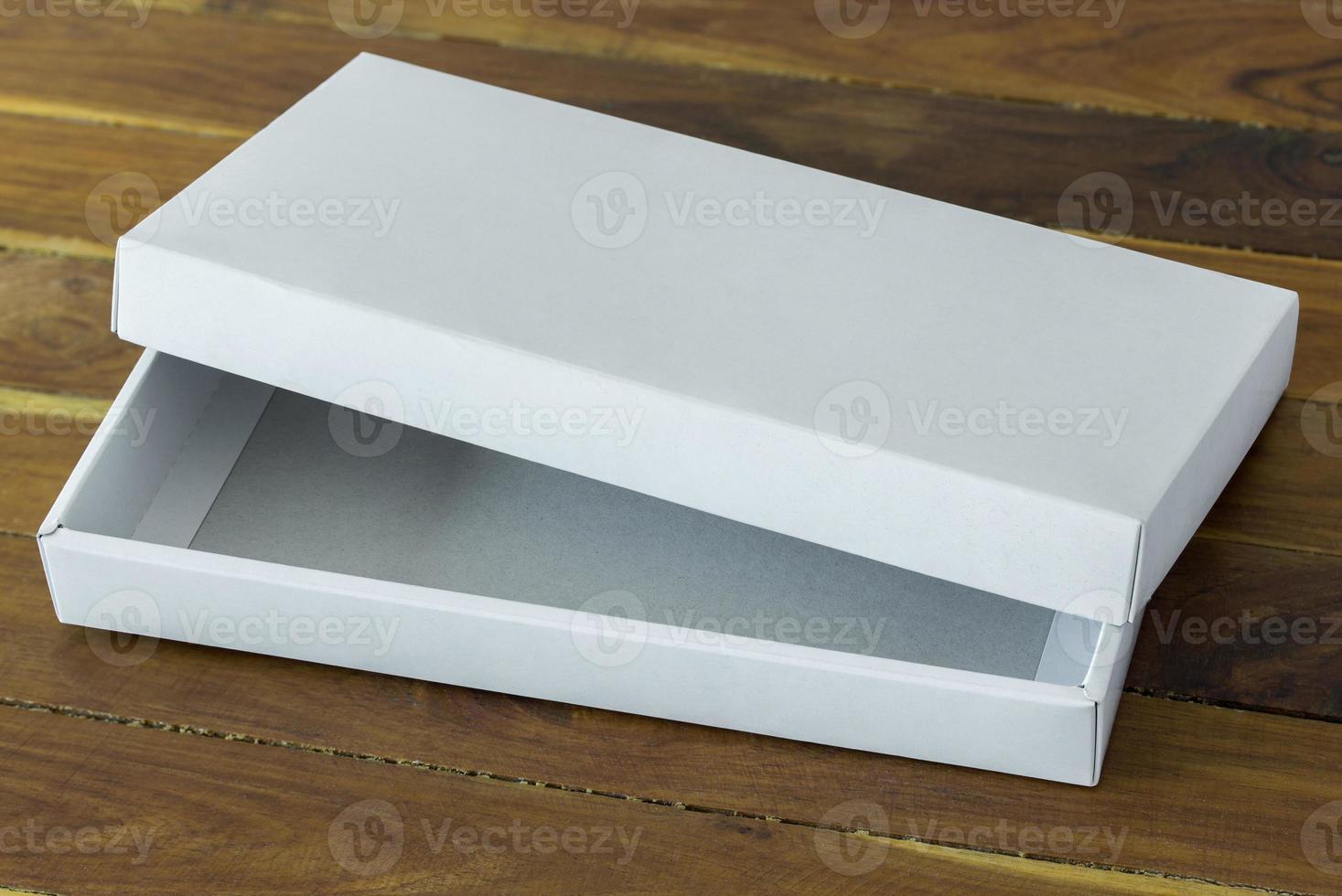 abierto blanco cartulina paquete caja Bosquejo en oscuro de madera mesa foto