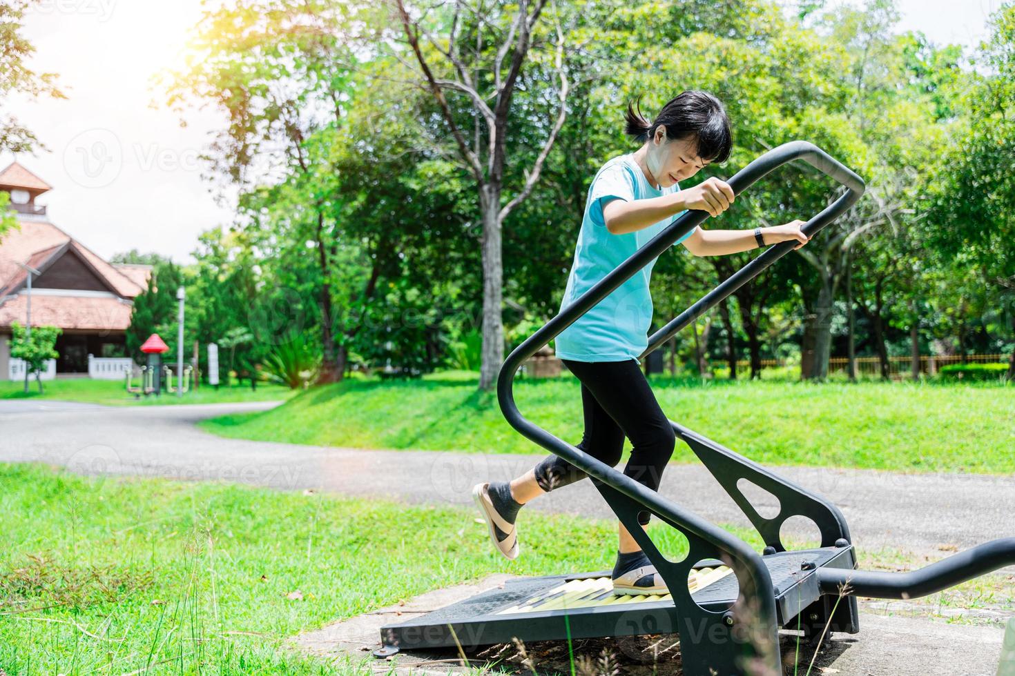 Close up of Child girl running on a treadmill for exercise at the playground in park outdoor. Fitness and healthy lifestyle concept photo
