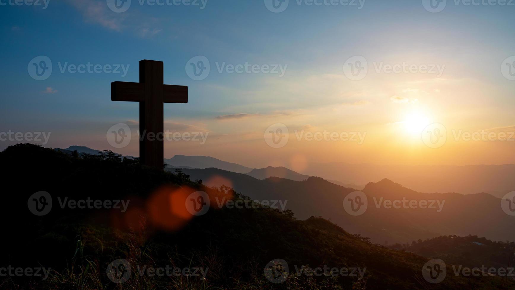 Silhouettes of Christian cross symbol on top mountain at sunrise sky background. Concept of Crucifixion Of Jesus Christ. photo