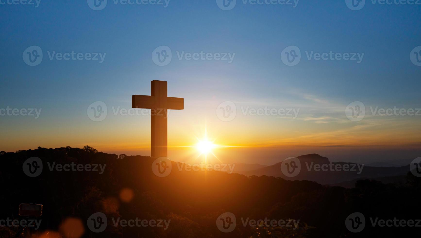 Silhouettes of Christian cross symbol on top mountain at sunrise sky background. Concept of Crucifixion Of Jesus Christ. photo