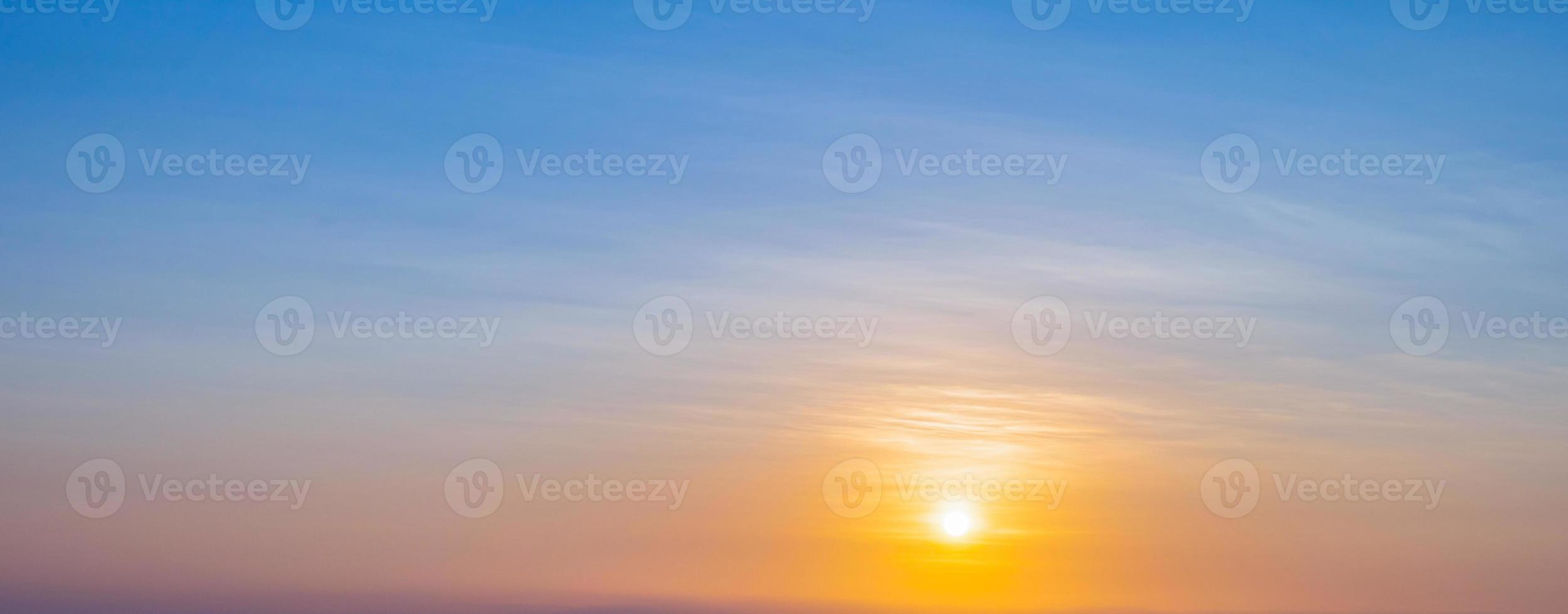 Sunset sky scene with a bright golden light. Beautiful sunrise with clouds soft. Nature background concept photo