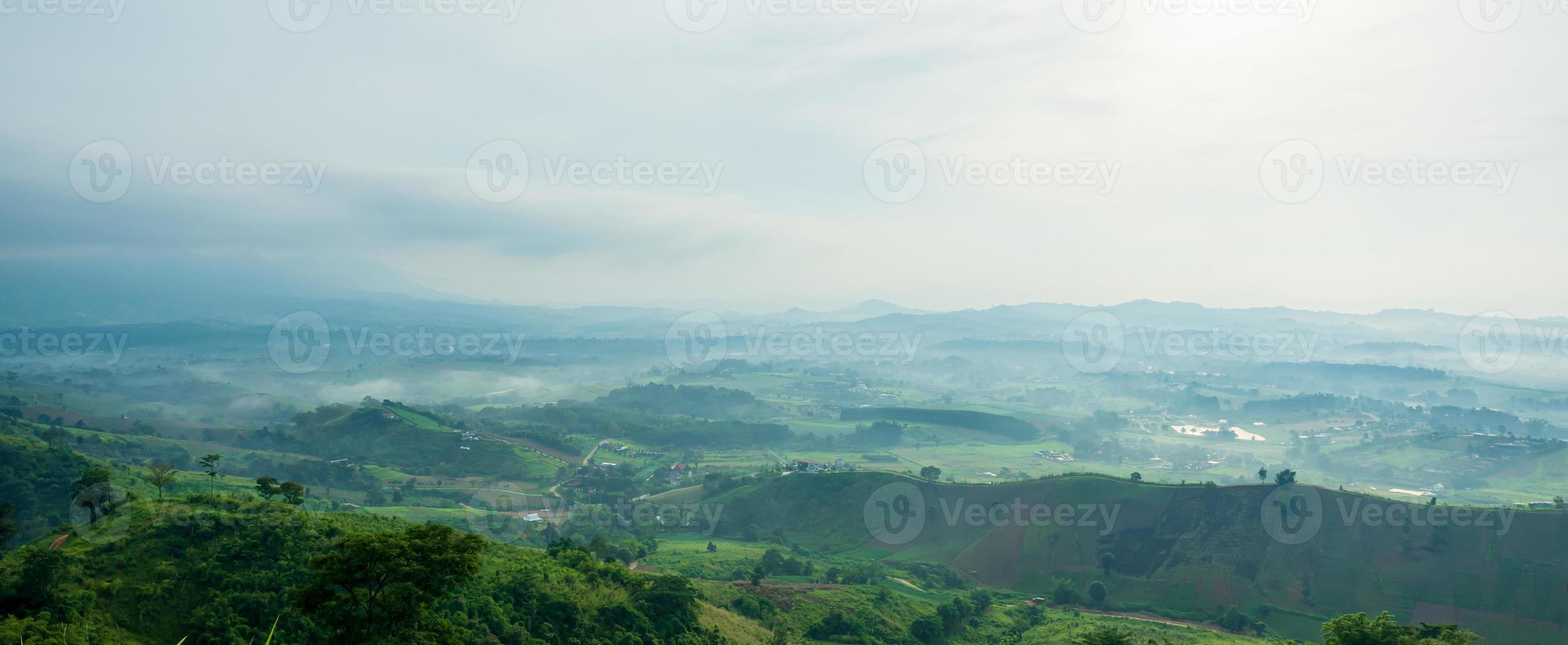 Beautiful landscape of mountain with view into misty valley in morning time. fog in a mountains valley panorama view. photo