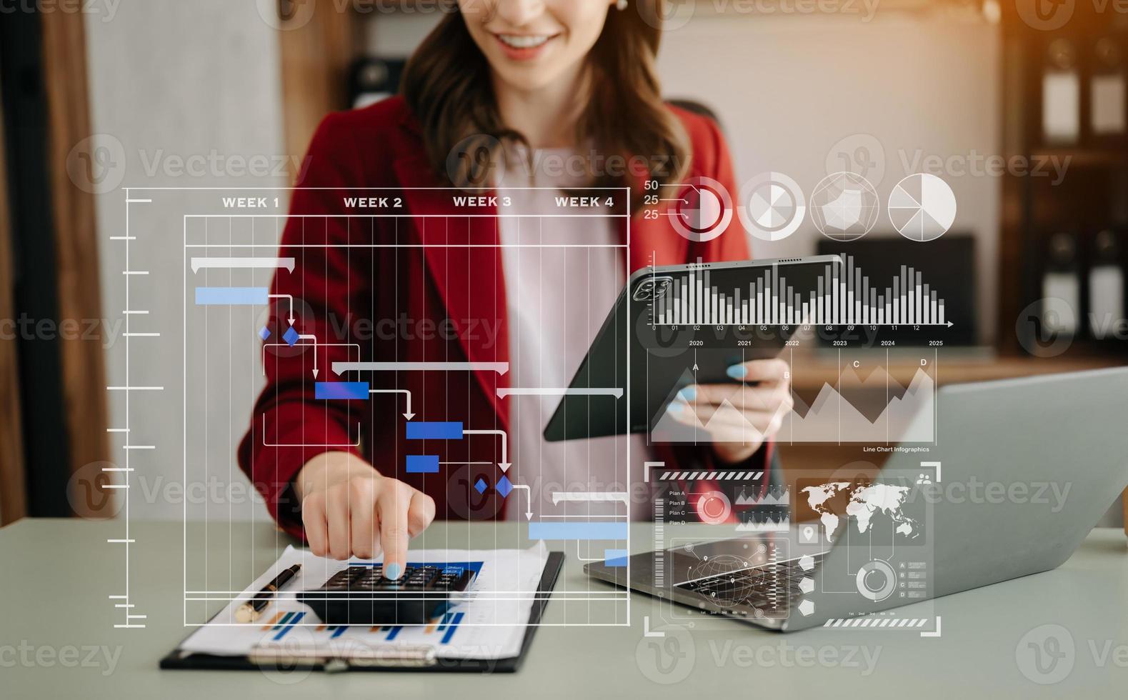 Businesswoman hand Project manager working and update tasks and Gantt chart scheduling virtual diagram.with smart phone, tablet and laptop photo