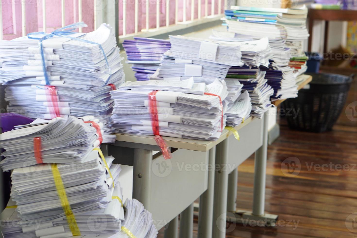 Stack of used paper test after the examination in classroom, combine to use next time or take to recycle process. Concept, paper garbage management. Reduce reuse, recycle for environment. Sort garbage photo