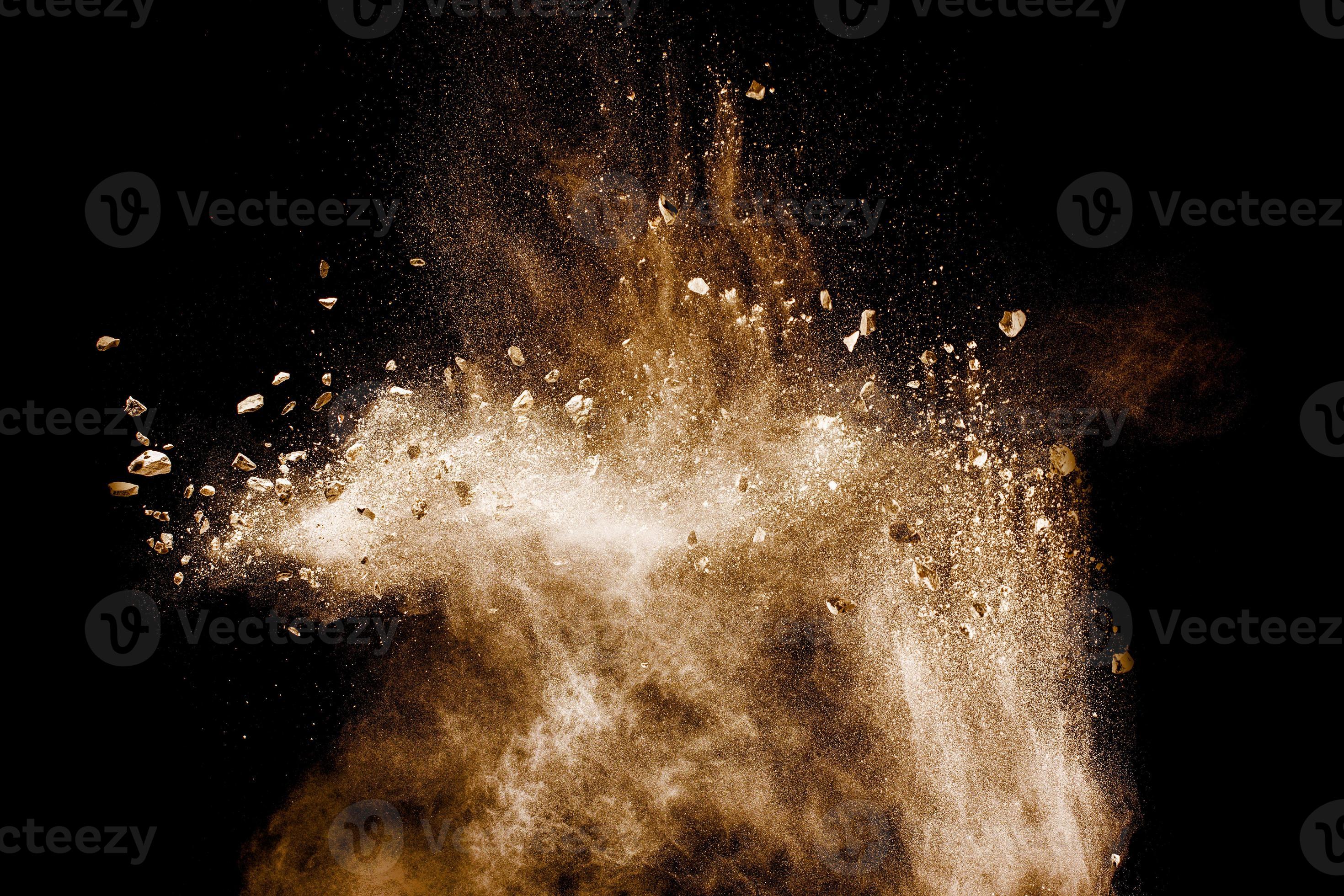 Split debris of stone exploding with brown powder against white