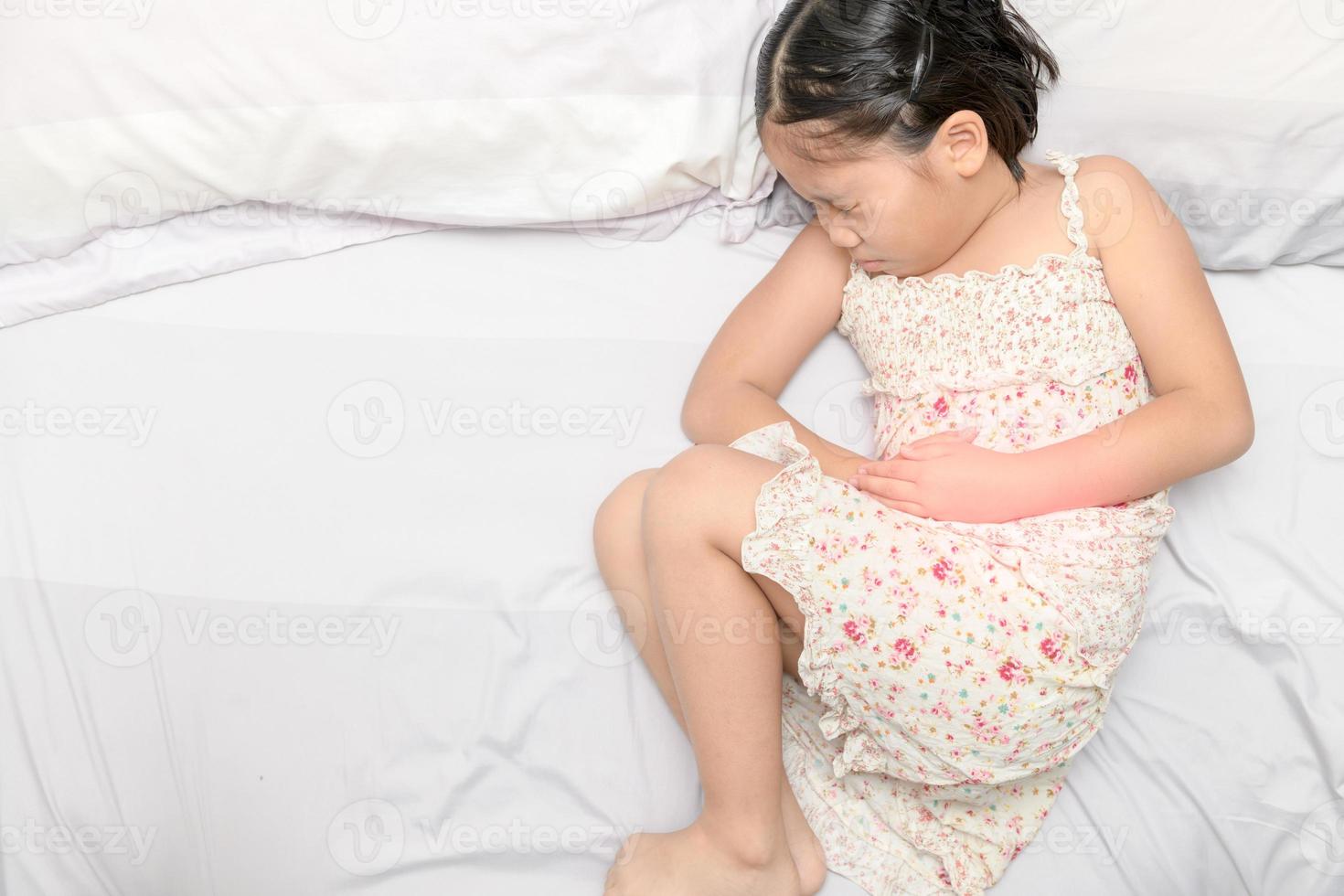 asian girl suffering from stomachache photo