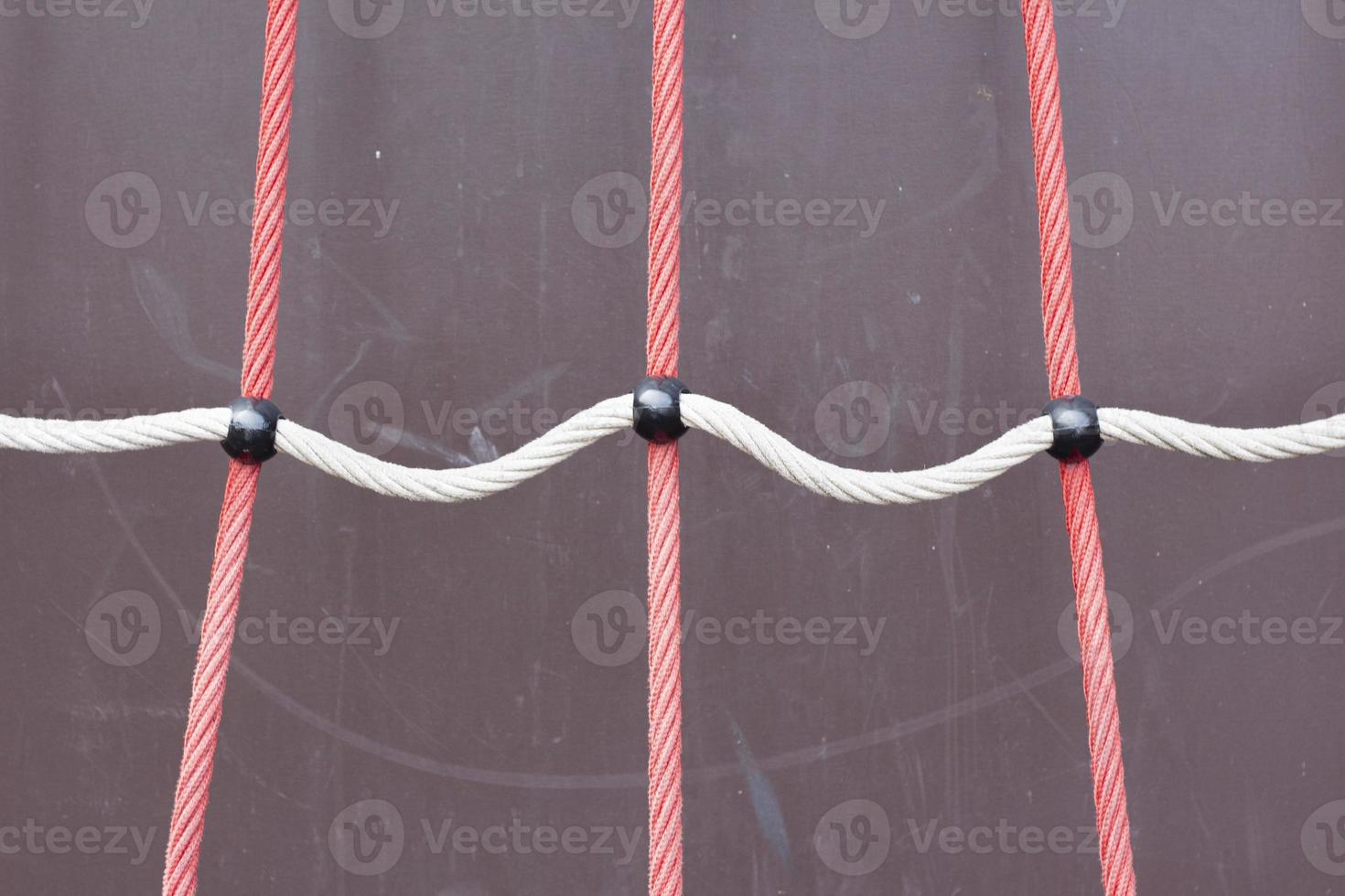 A closeup shot of a rope on a playground with a blurred background. Children's playground rope game photo