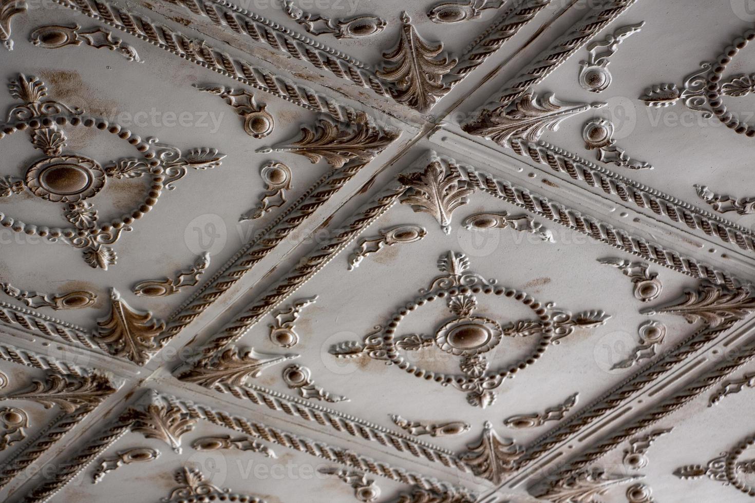 Detail of the ceiling of an antique building. Decorative antique design pattern. Details of the interior of the mansion ceiling photo