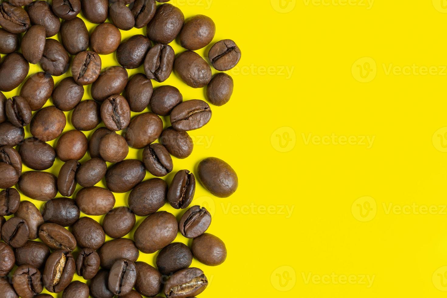 Black coffee beans on yellow background. Left vertical location objects, copy space for text on right photo