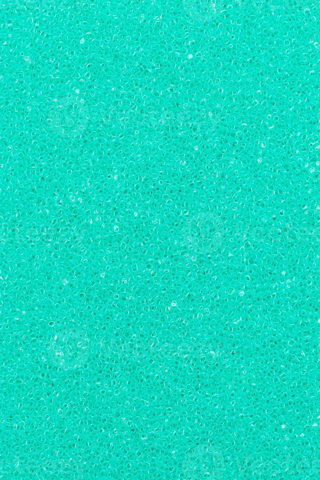 Turquoise color foam porous abstract background. Vertical composition for design, colored backdrop photo