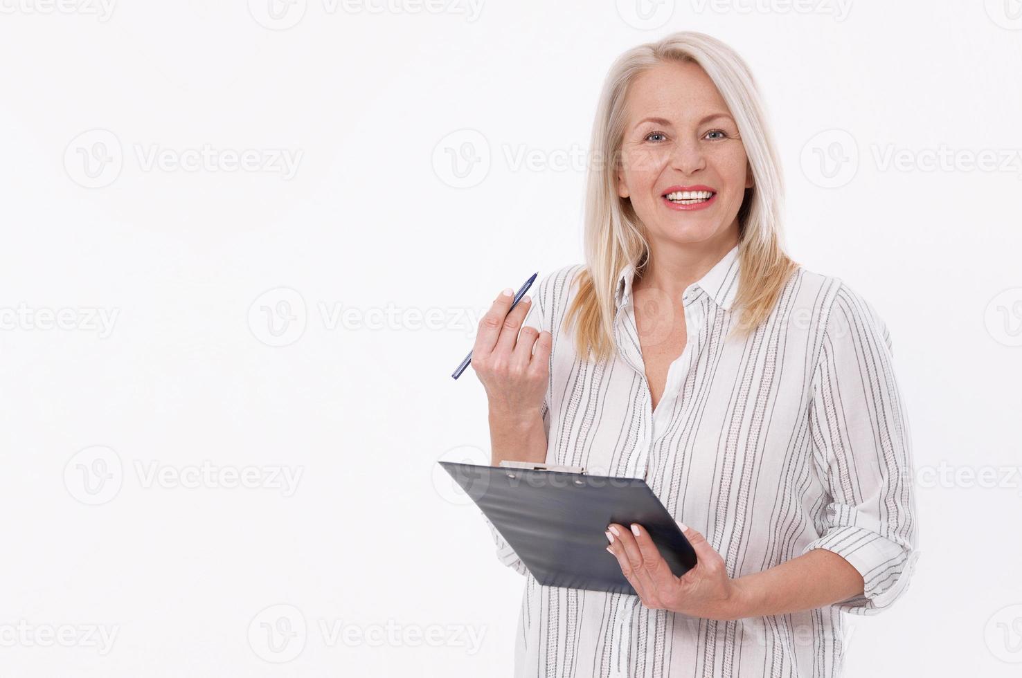 Business woman holds a pen and a folder with files isolated on white background photo