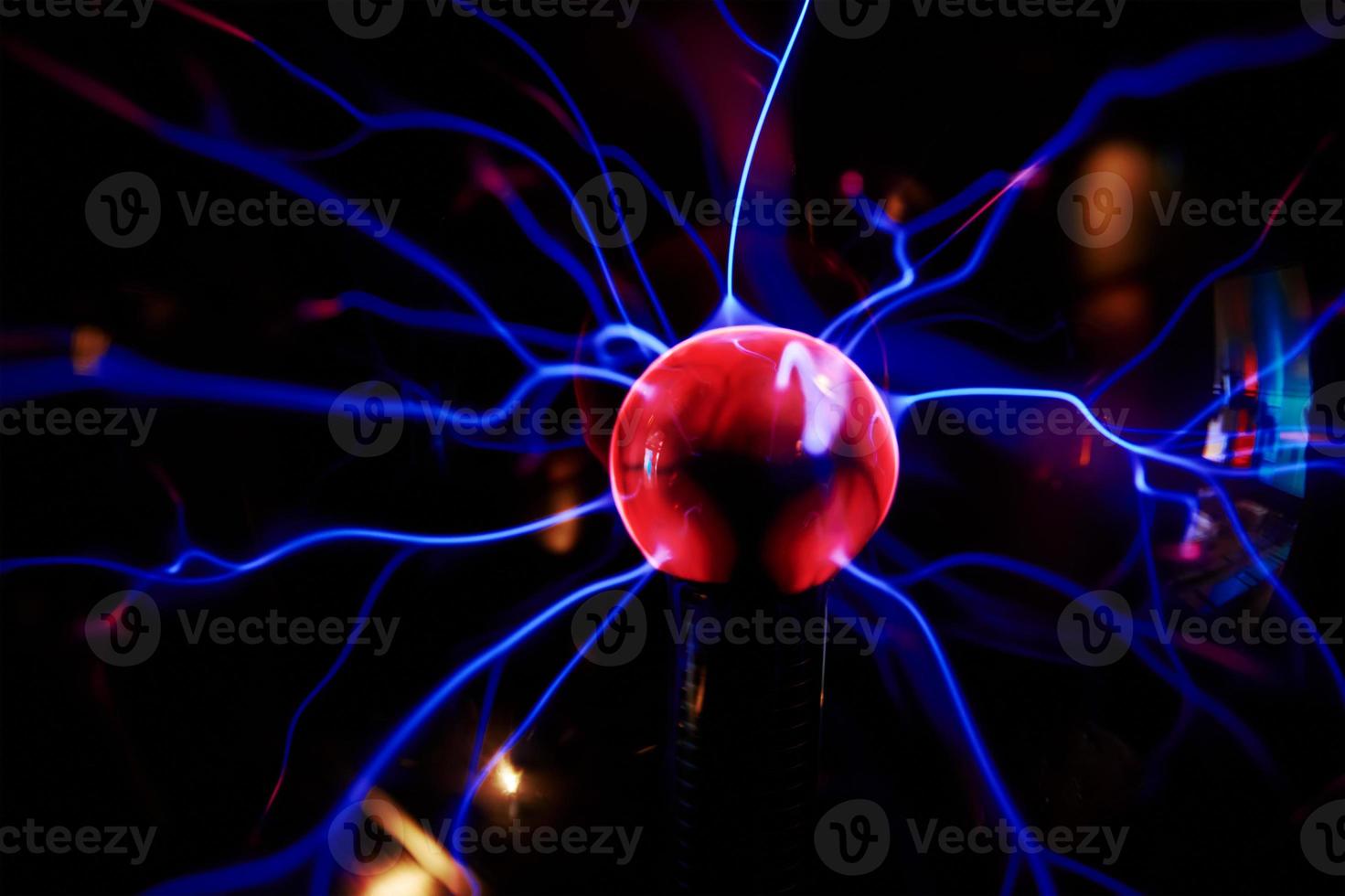 Plasma ball with energy rays on dark background photo