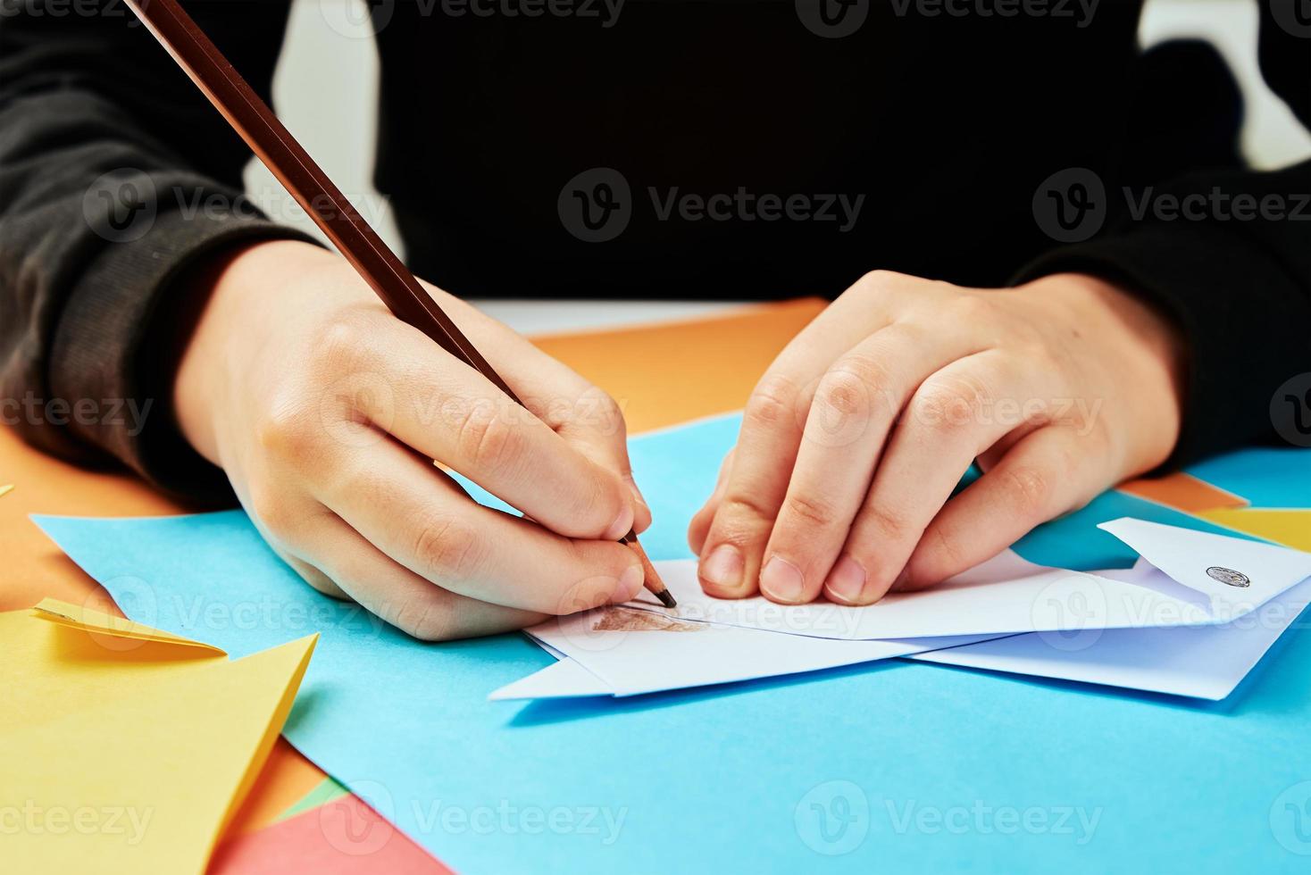Boy making paper dog origami photo