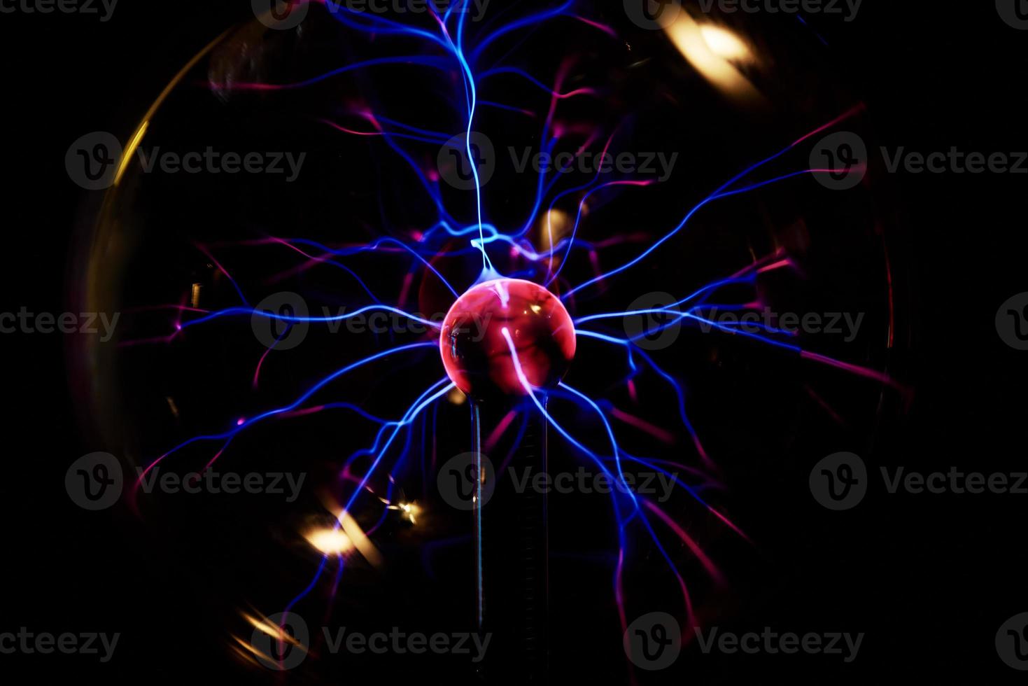 Plasma ball with energy rays on dark background photo