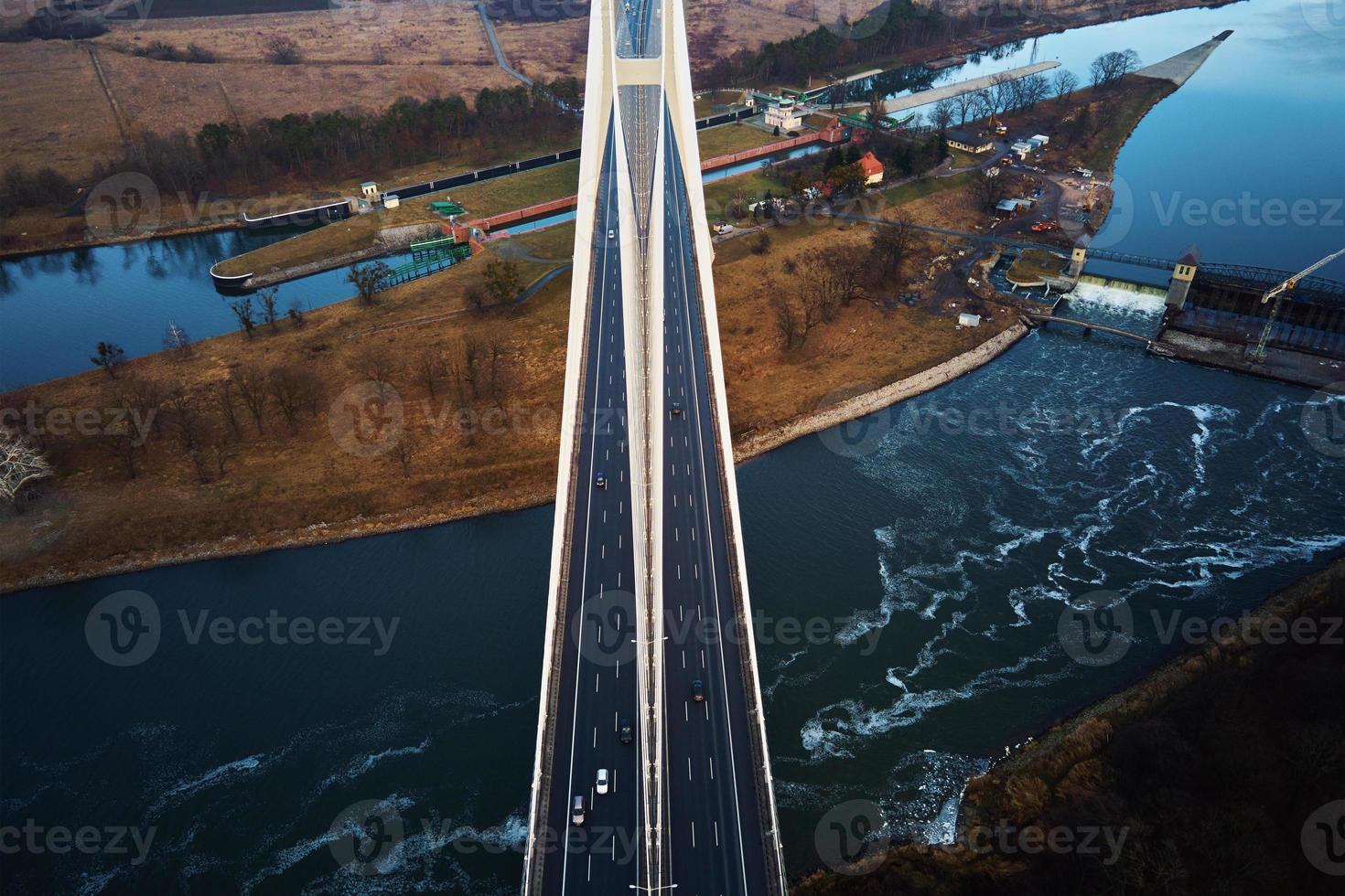 Large bridge over river with cars traffic photo